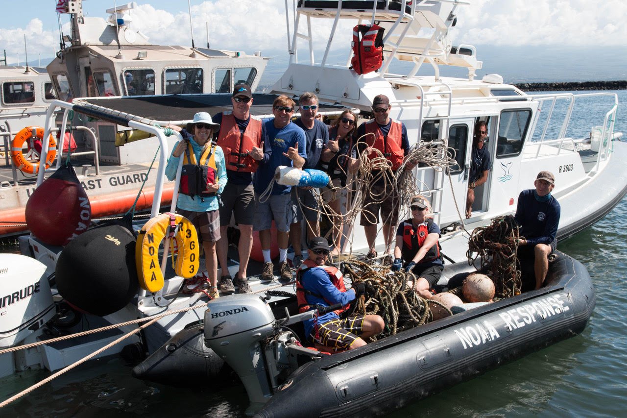 NOAA Fisheries photo by Ed Lyman showing authorized large-whale responders with fishing gear removed from an entangled whale